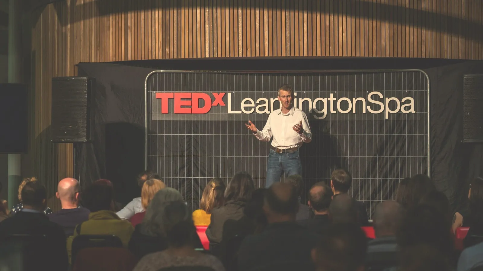 Andrew Pain delivering his TEDx talk on stage